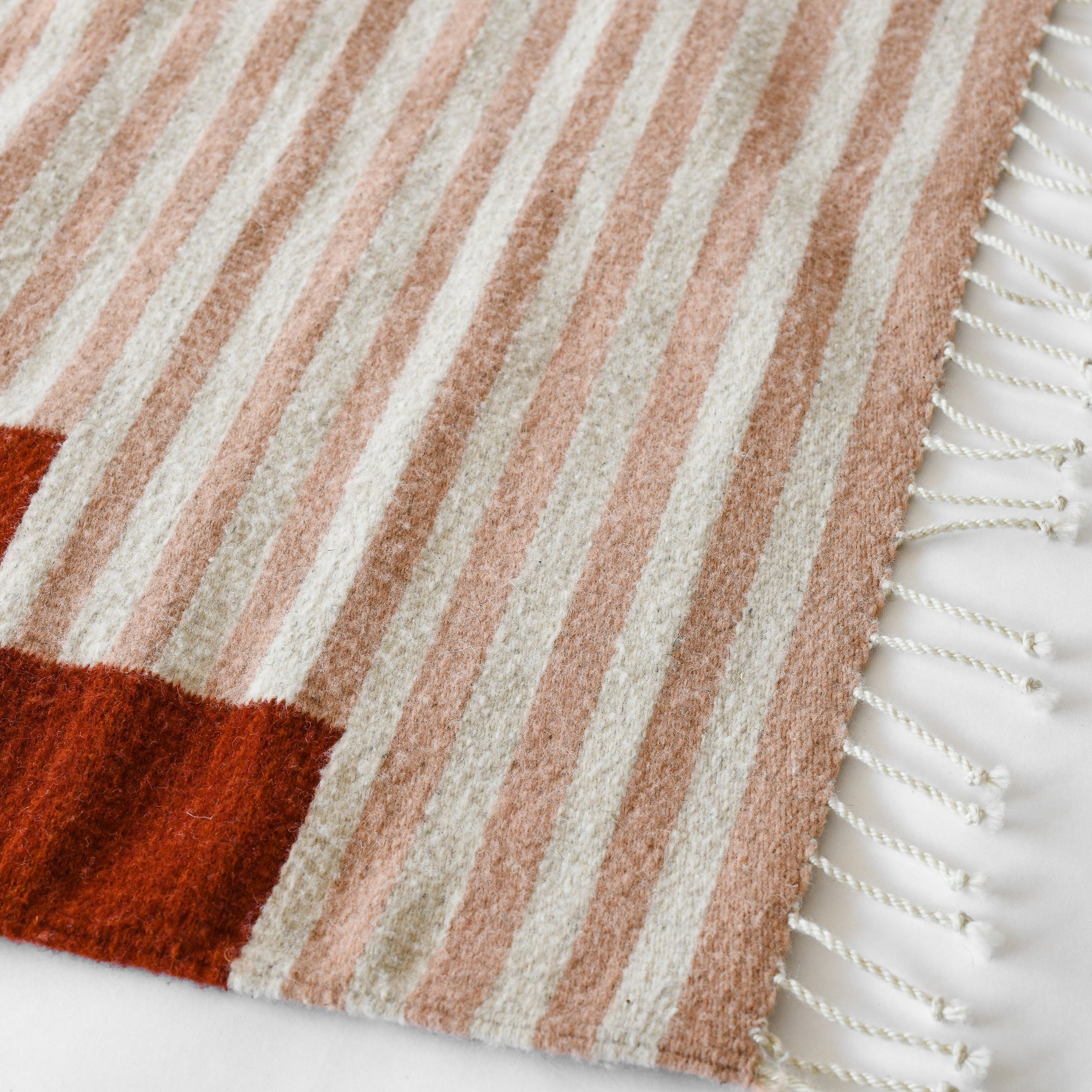 LOOM Imports handwoven ethical flat weave wool rugs. B Corp certified, women owned, fair trade, natural sustainable materials.